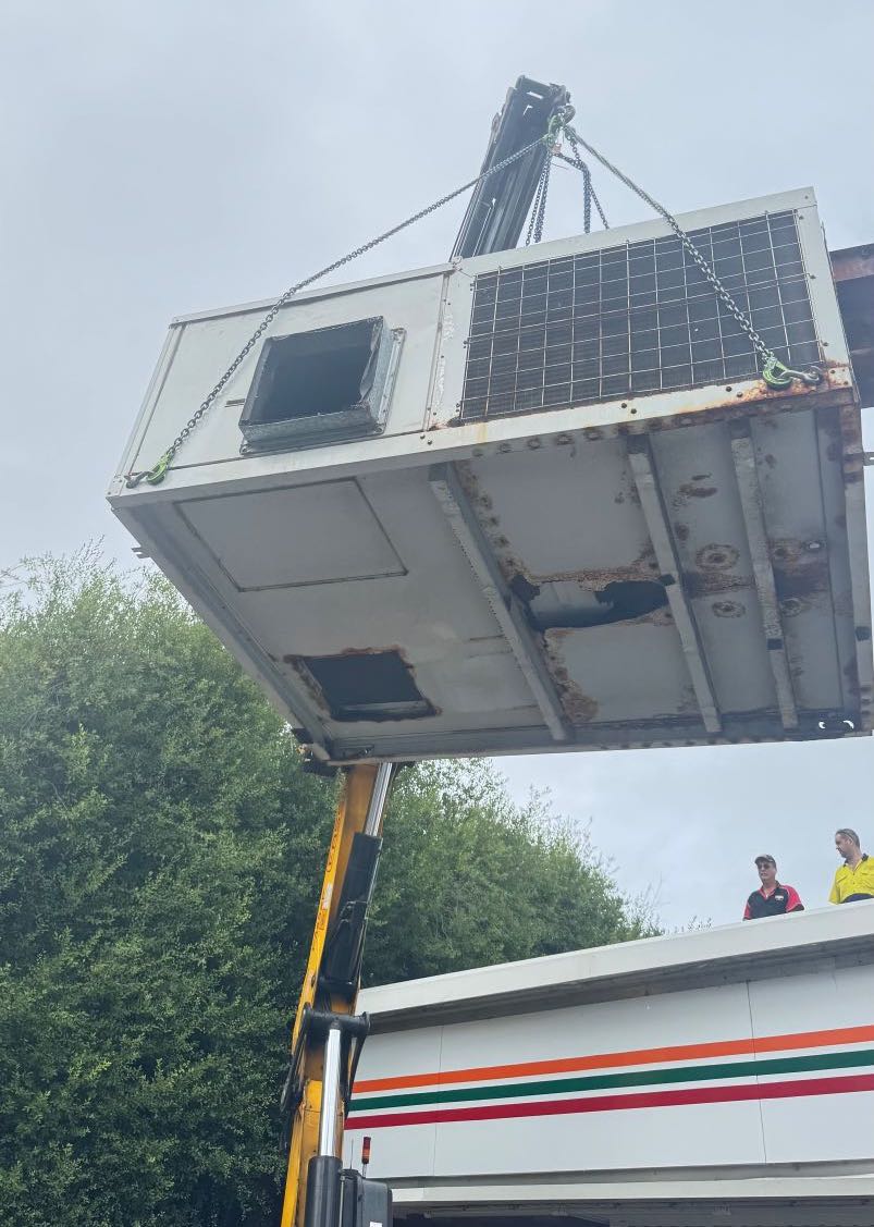 Chatfield OzCool - OLD ON CRANE 2 Rusted airconditioning unit being removed from roof via crane